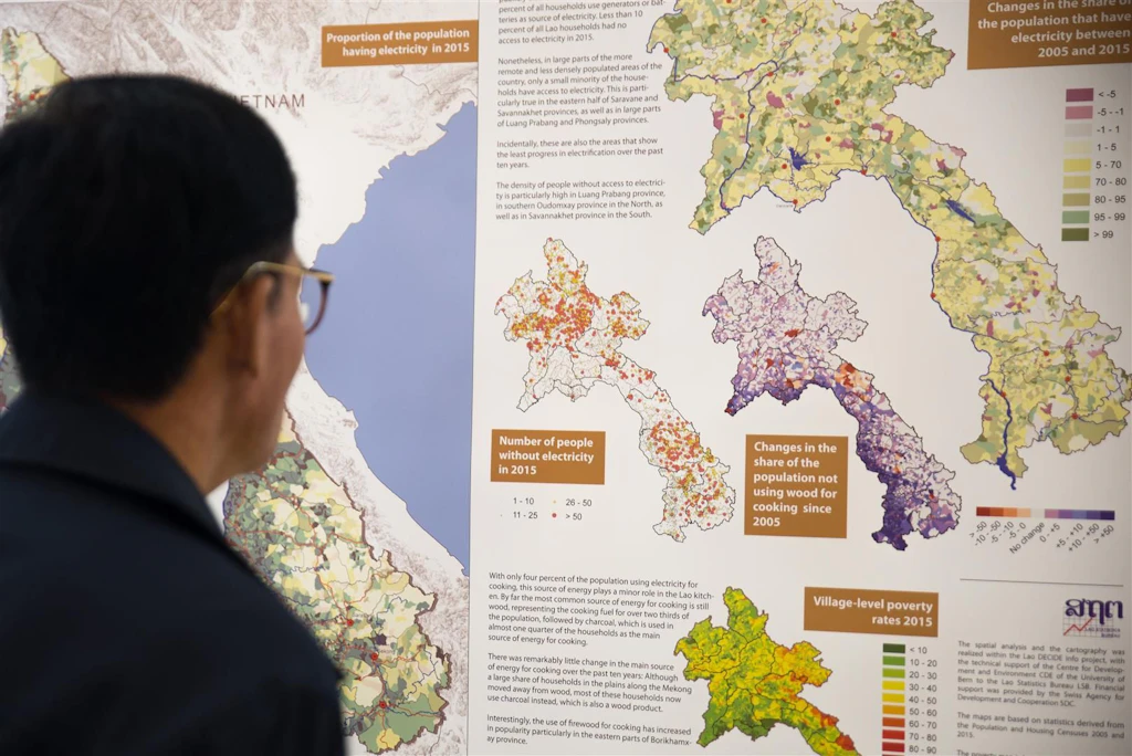 A gentlemen glancing at statistical information of Laos.